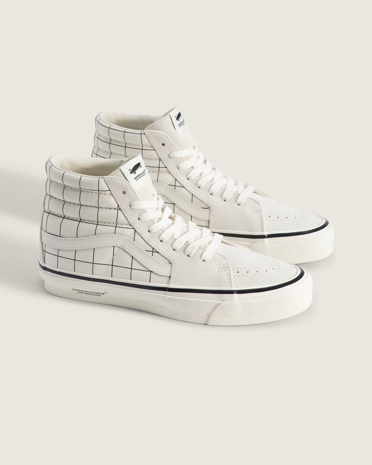 Белые высокие кеды Vans в клетку на светлом фоне