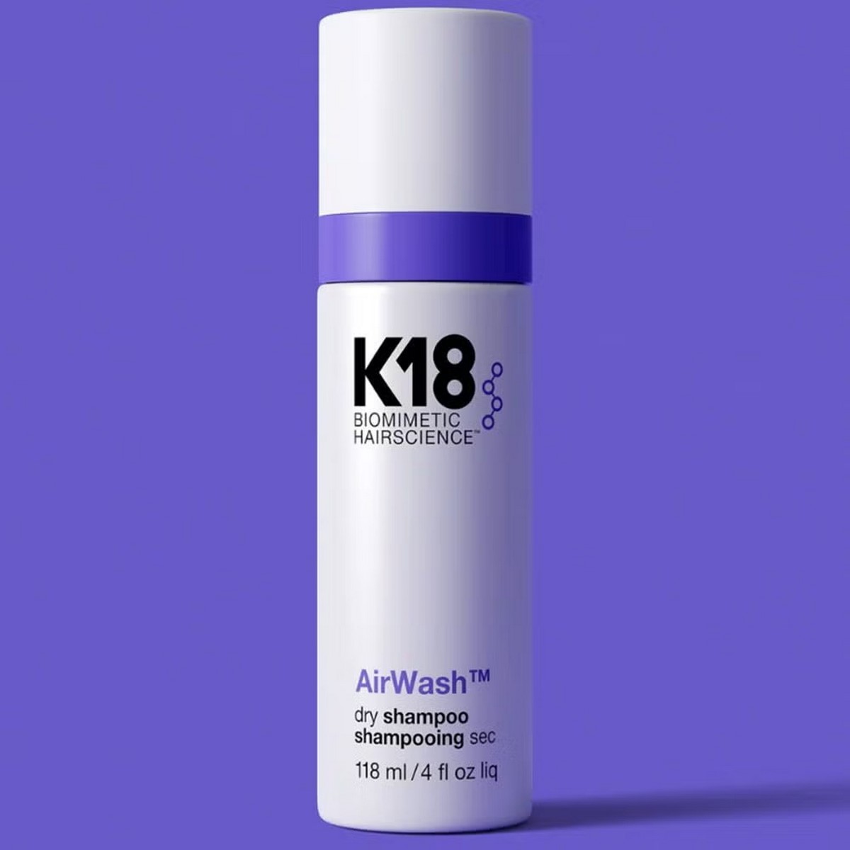 Флакон сухого шампуня K18 AirWash на фиолетовом фоне